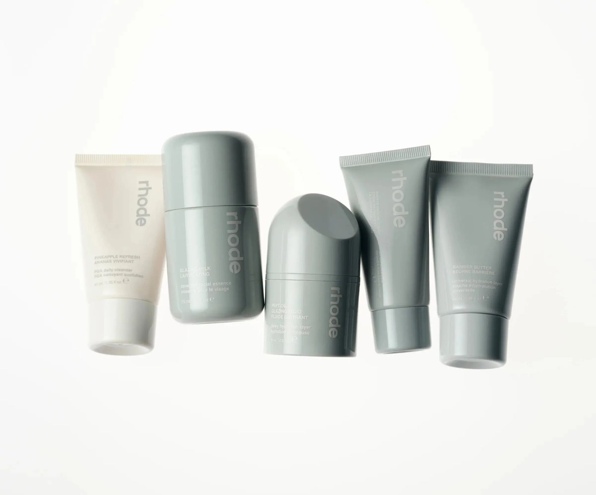 THE TRAVEL SET five-piece mini skincare set by Rhode - portable travel-size skincare essentials for hydrated glowing skin on-the-go